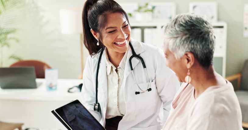 A clinician at a hospital bedside